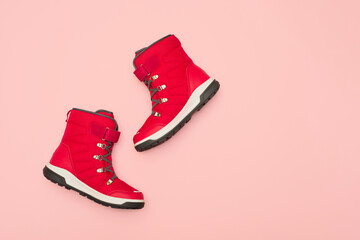 Kids or teenage pink winter boots isolated on pink background. Winter boots for girls.