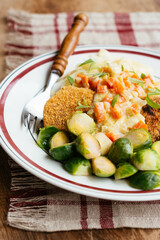 Vegan Schnitzel on noodles with a creamy tarragon vegetable sauce and Brussels sprouts.