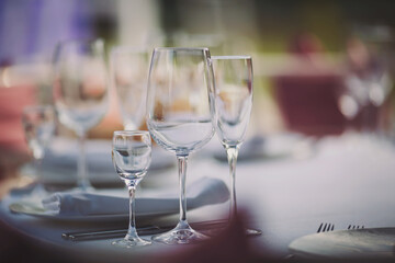 Elegant dinner table setting in restaurant or hotel with wine glasses