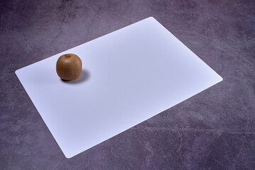 Kiwi on white stone mat
