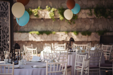 Holiday party decoration. The Colorful balloons attached to the table. Decorated balloons for birthday.