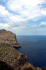 Fototapeta na wymiar A beautiful landscape with a rocky cape and amazing clouds. Mediterranean Sea, Majorca Island, Spain.