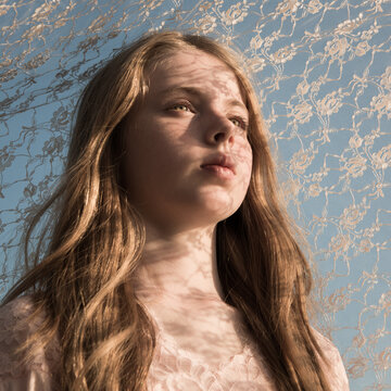 Portrait Of A Young Beautiful Girl Covered By A Shadow Pattern Of Lace In Natural Light