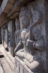 Fototapeta na wymiar A stone bas relief depicting a god at the ancient Prambanan Temple complex in Yogyakarta, Indonesia.