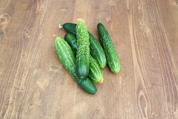 fresh young cucumbers on a wooden table