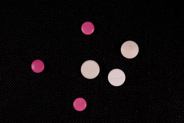 Antibiotic pills on a black background. Healthcare and medicine concept