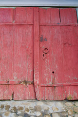 Old red and rusty wooden door at Bern, capital of Switzerland.