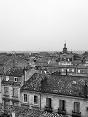 Dramatic Black and White Shot of Bordeaux Rooftops and Church Against a Grey Sky