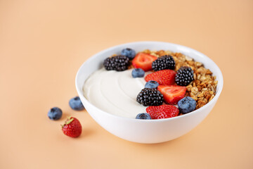 Fresh breakfast with greek yogurt nuts oatmeal granola with berries in a bowl