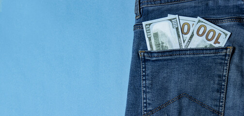 Many greenback in a pocket of jeans
