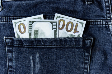 Many greenback in a pocket of jeans