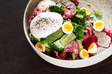 gourmet salad with mozzarella and poached egg