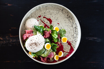 gourmet salad with mozzarella and poached egg