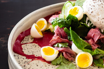 gourmet salad with mozzarella and poached egg