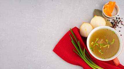 hot homemade beef bone broth with collagen and amino acids in red bowl