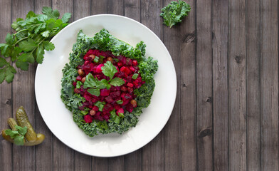 Beetroot salad, healthy organic vinaigrette placed on kale leaf, Russian cuisine 