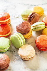 colorful macaroons on the marble background