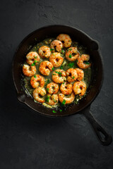 Shrimps with garlic, olive oil and parsley in frypan