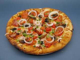 fresh whole pizza with mushrooms, pepperoni sausage and onions