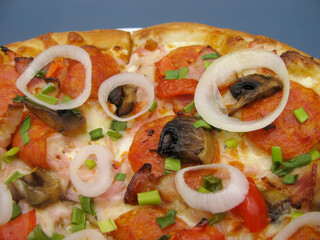 fresh whole pizza with mushrooms, pepperoni sausage and onions