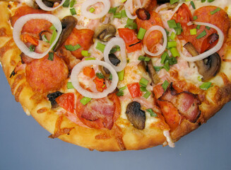 fresh whole pizza with mushrooms, pepperoni sausage and onions