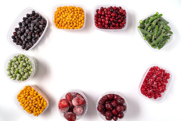 Frozen berries and vegetables in plastic boxes isolated on white background.
