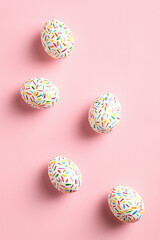 Colorful Easter eggs on pink background. Happy Easter flat lay composition. Minimal style.