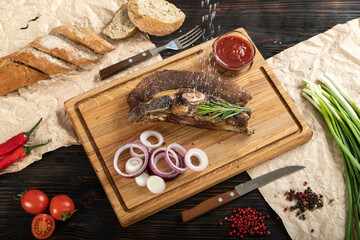 Roasted beef on the bone on a board for serving.
