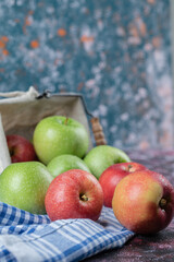 Red and green apples isolated on a blue checked towel
