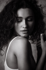 Black and White Portrait of Beautiful young curly woman.