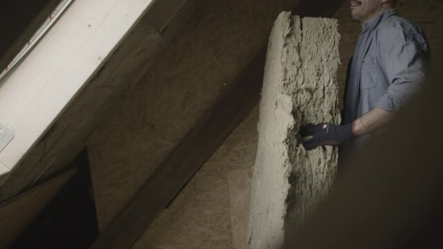 Handyman putting insolation in a wall