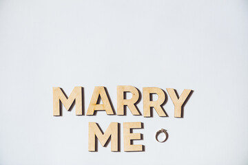 Alphabet letter wooden letters with words Marry me. Marriage proposal and love concept for Valentine`s day with wedding or engagement 