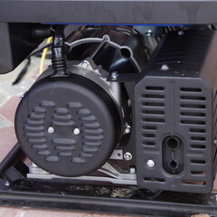 Portable gasoline invertor alternator dynamo machine on frame closeup
