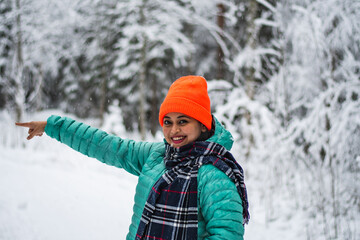 Fototapeta na wymiar An asian beautiful model lady in a winter wonderland enjoying the snow wearing colourful cloths