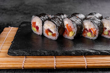 Sushi Rolls with fresh fish and cheese inside. Roll on glass black background. Sushi menu. Japanese...