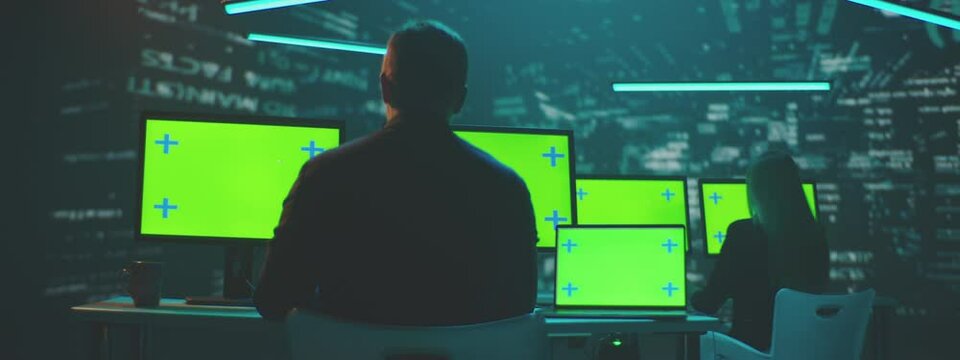 Colleagues working in a Modern Technical Support Control Room with greenscreen displays.