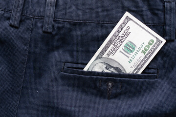 One hundred American Dollars Banknote in a jeans pocket on rotating table. Extreme close-up, Shallow Depth of Field. Business