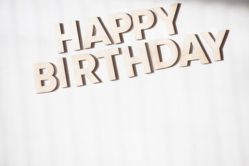 Fototapeta na wymiar Wooden letters on a background. Congratulations with birth day