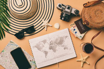 Top view travel concept with retro camera films, map and passport on light orange background with...