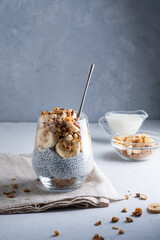Healthy chia pudding with coconut milk, banana, walnut, chio seeds, granola. Vegan healthy breakfast, clean eating.