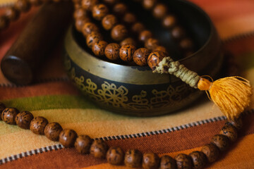 Tibetan bowl with a mala on a nice colorful cushion