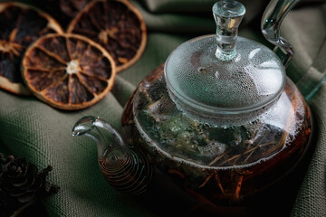 Clear glass teapot with dark tea.