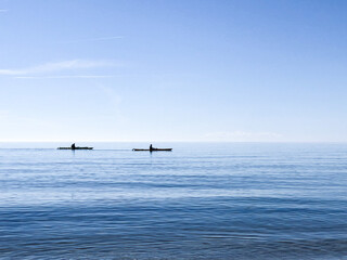 Photo of silhouettes kayaking