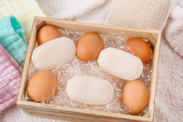 Little soaps inside a wooden box with eggs and pastel colored muslin cotton for egg white soaps...