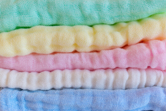 Gentle Cleansing Of The Skin Concept. Soft And Delicate Fabrics To Wash Sensitive Skin Or Newborns And Baby Body. Set Of Pastel Colored Muslin Cotton Towels. Microfiber Cloth And Sponge Extra Smooth.