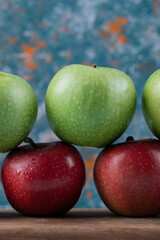 Juicy apples in a row on a wooden board