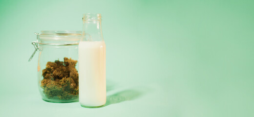 Hemp milk in bottle banner. Cannabis buds jar. Plant based drinks. Lactose free. Copy space