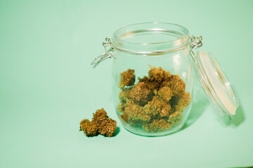 Cannabis buds stored in glass jar. Medical marijuana shop. 4/20 culture