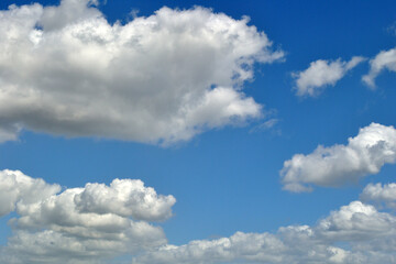 Fluffy White Clouds against Blue Sky 