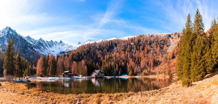 small high mountain lake surrounded by pine trees © Marino Bocelli